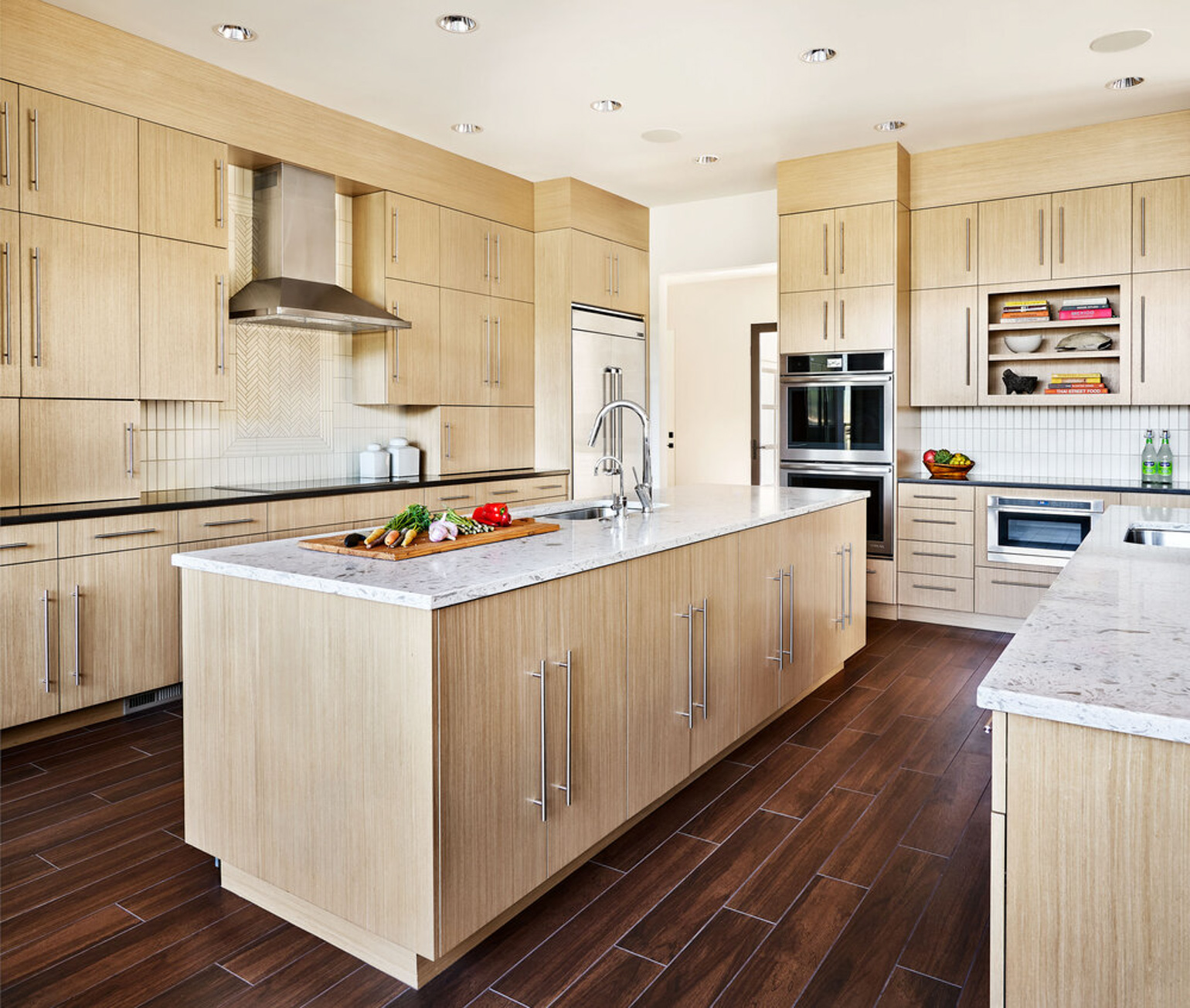 LED ceiling recessed lights in wooden cabinets and island kitchen.