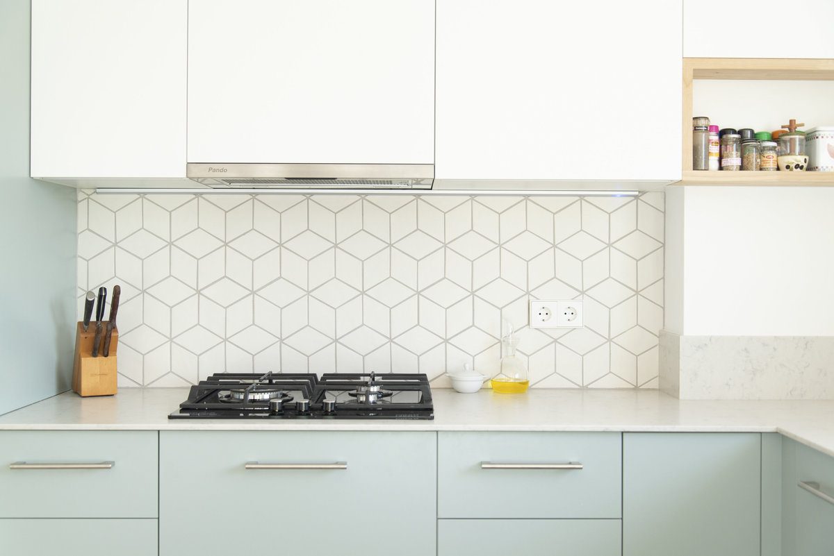 Ceramic backsplash with diamond shaped tiles installed in a kitchen