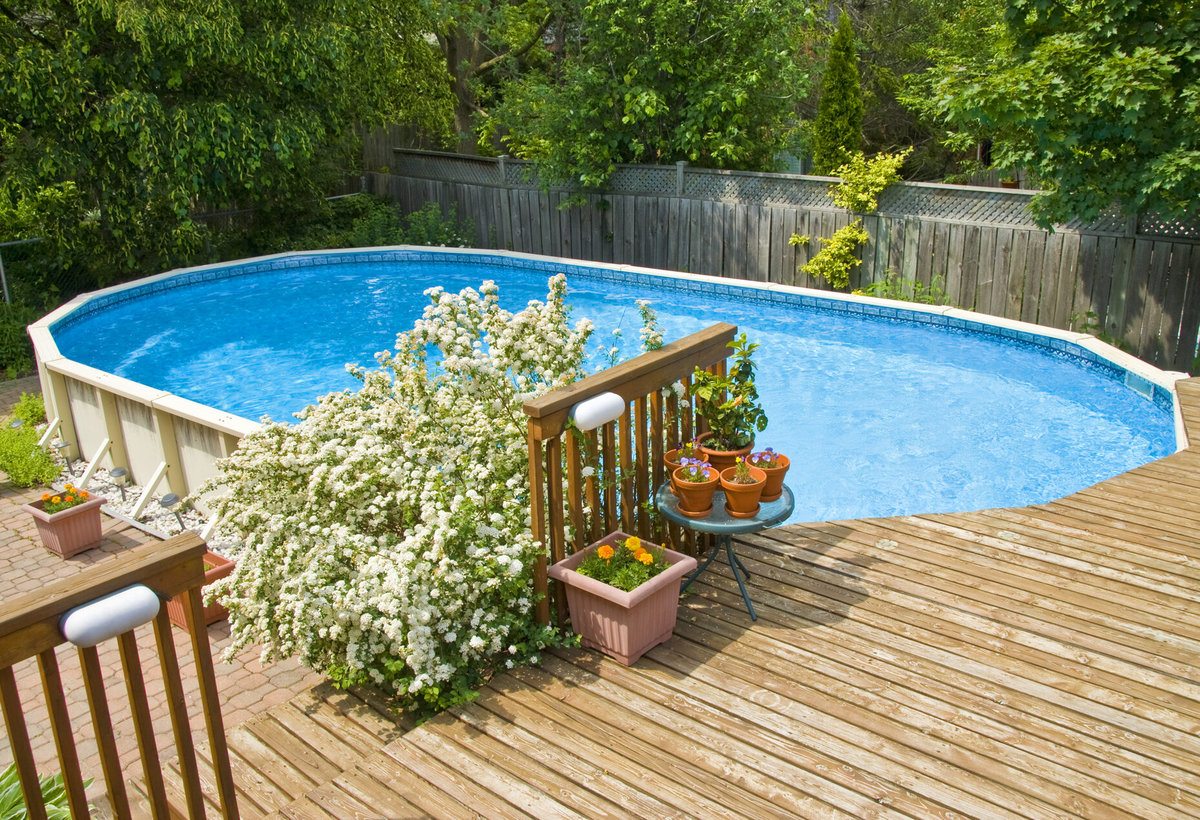 Wooden Above-Ground Side Pool Deck in Leafy Backyard Wooden Above-Ground Side Pool Deck in Leafy Backyard