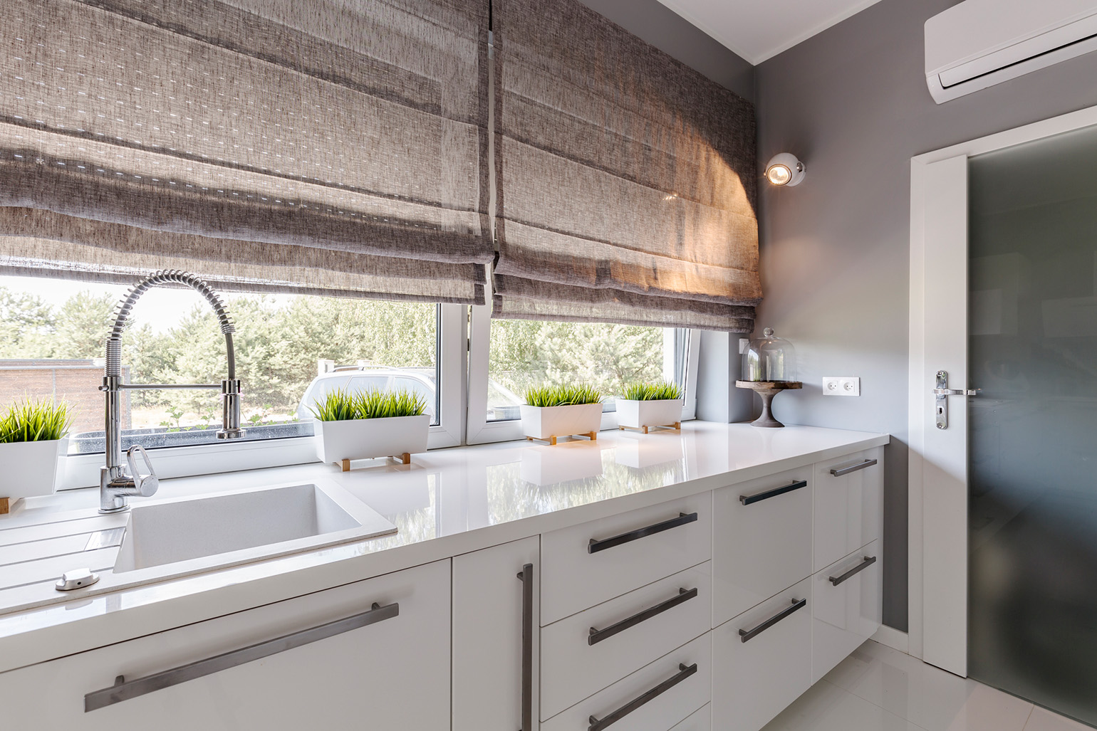 The earthy color shades on the kitchen windows.