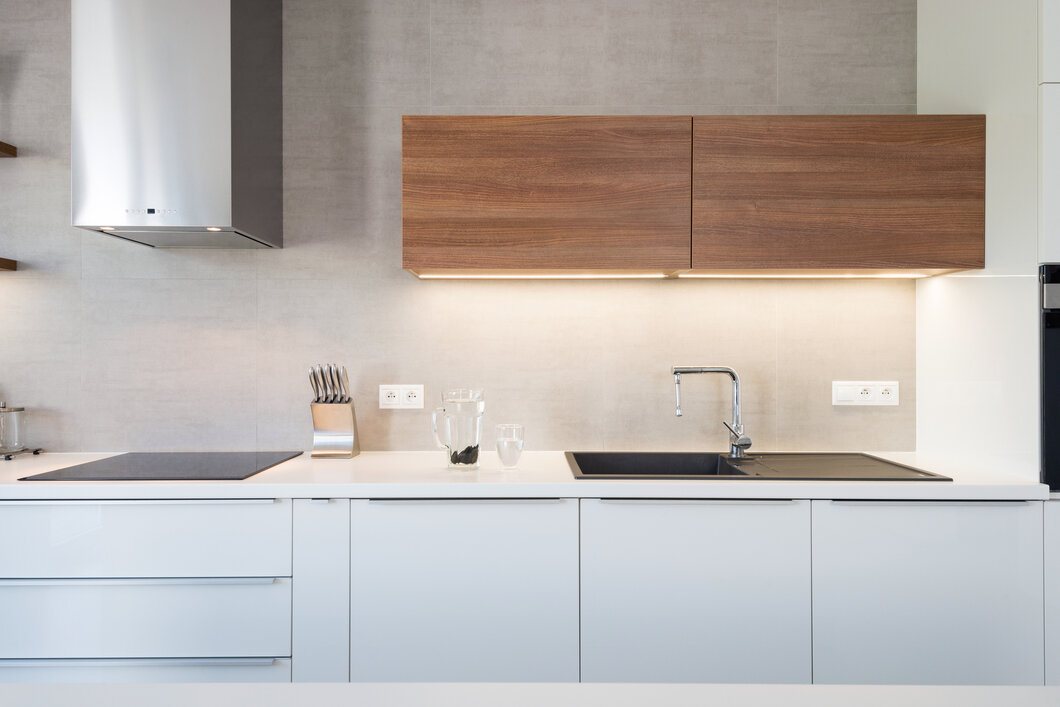 A modern kitchen with wooden and white cabinets.