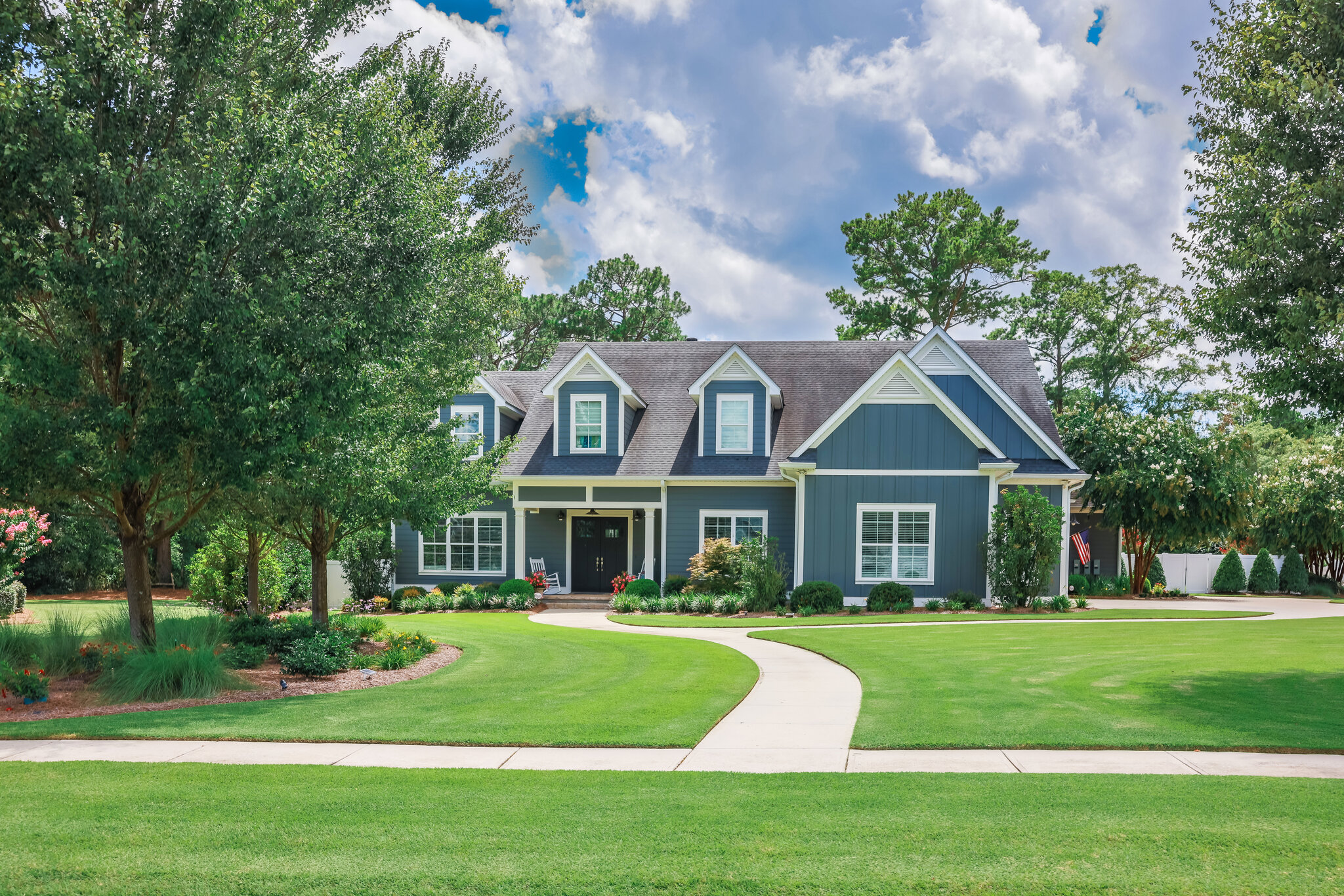 Exterior of a blue home with white trimmed windows