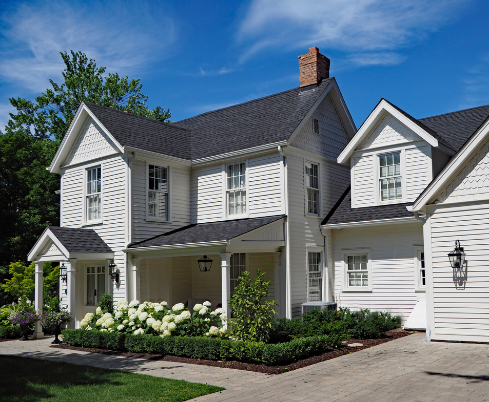  Exterior of a home with white siding and white window trims